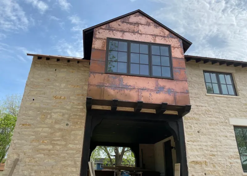 Copper metal panel facade on a stone building for Metal Roof Coating in Ogdensburg