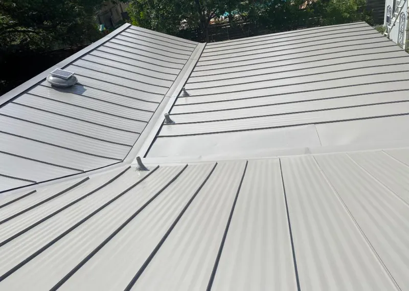 Solar attic fan installed on a metal roof for Roof Ventilation in Ogdensburg